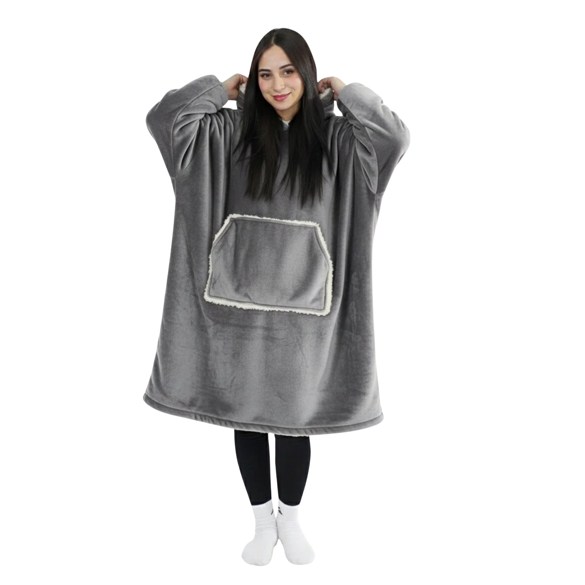 Person wearing a gray oversized hoodie with a front pocket on a white background